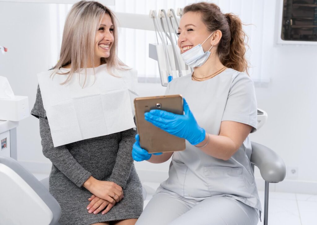 Dentist discussing a personalized full mouth reconstruction treatment plan with a patient during a dental consultation.