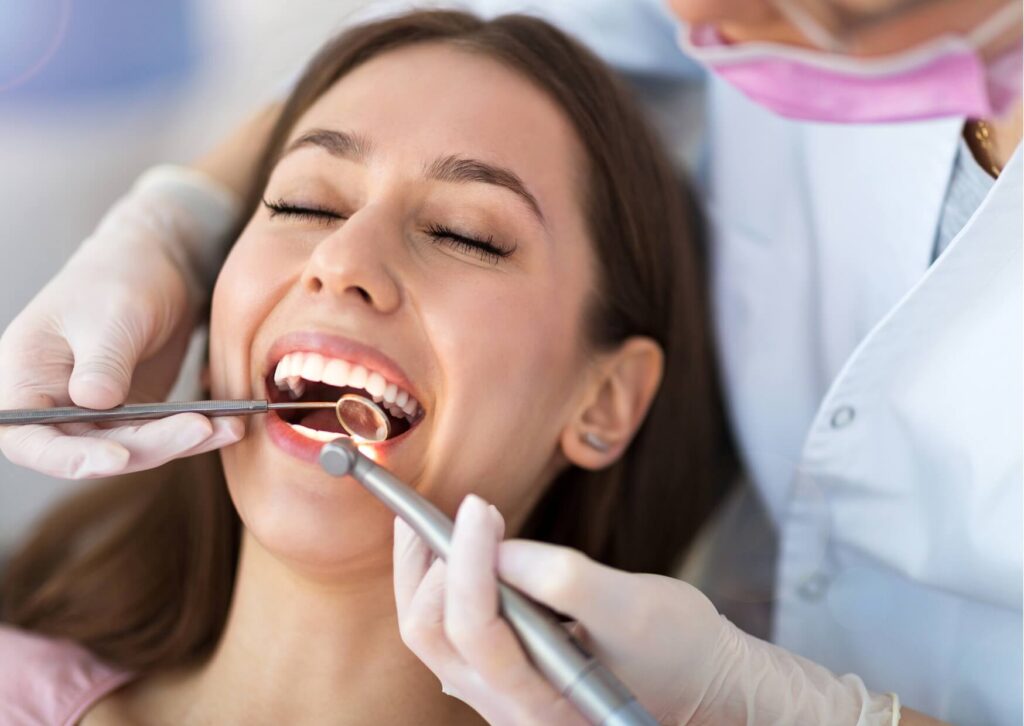 Patient receiving a dental evaluation to determine whether a crown or veneer is the best treatment option.