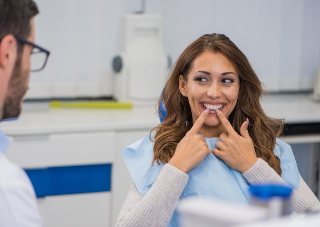Patient discussing a flipper tooth with a dentist during a consultation for temporary tooth replacement options.