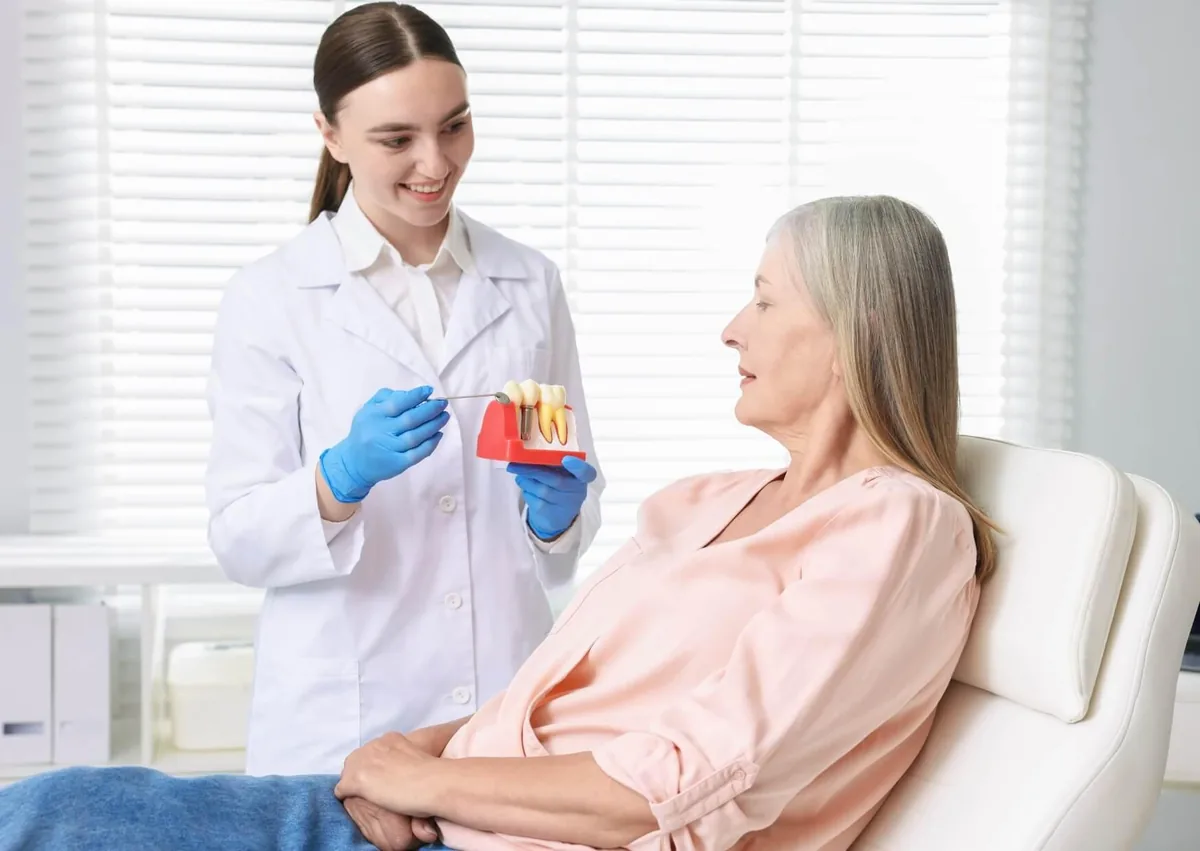 Dentist explaining affordable dental implants and treatment options to a patient during a consultation.